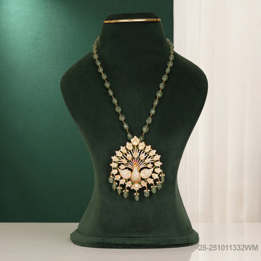 Necklace with a decorative pendant on a green mannequin bust against a green background